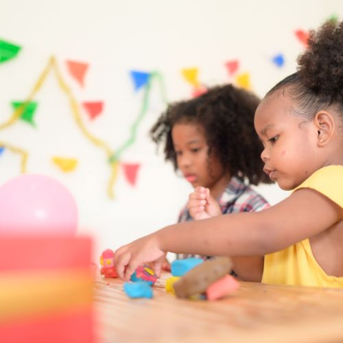 Two little girls Playing with plasticine